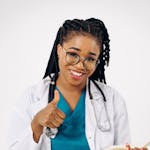 Confident female doctor in scrubs smiling and giving a thumbs up, representing healthcare professionalism.